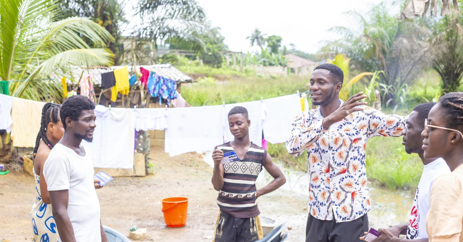The crew sharing the Gospel with a family in their compound at Dompim