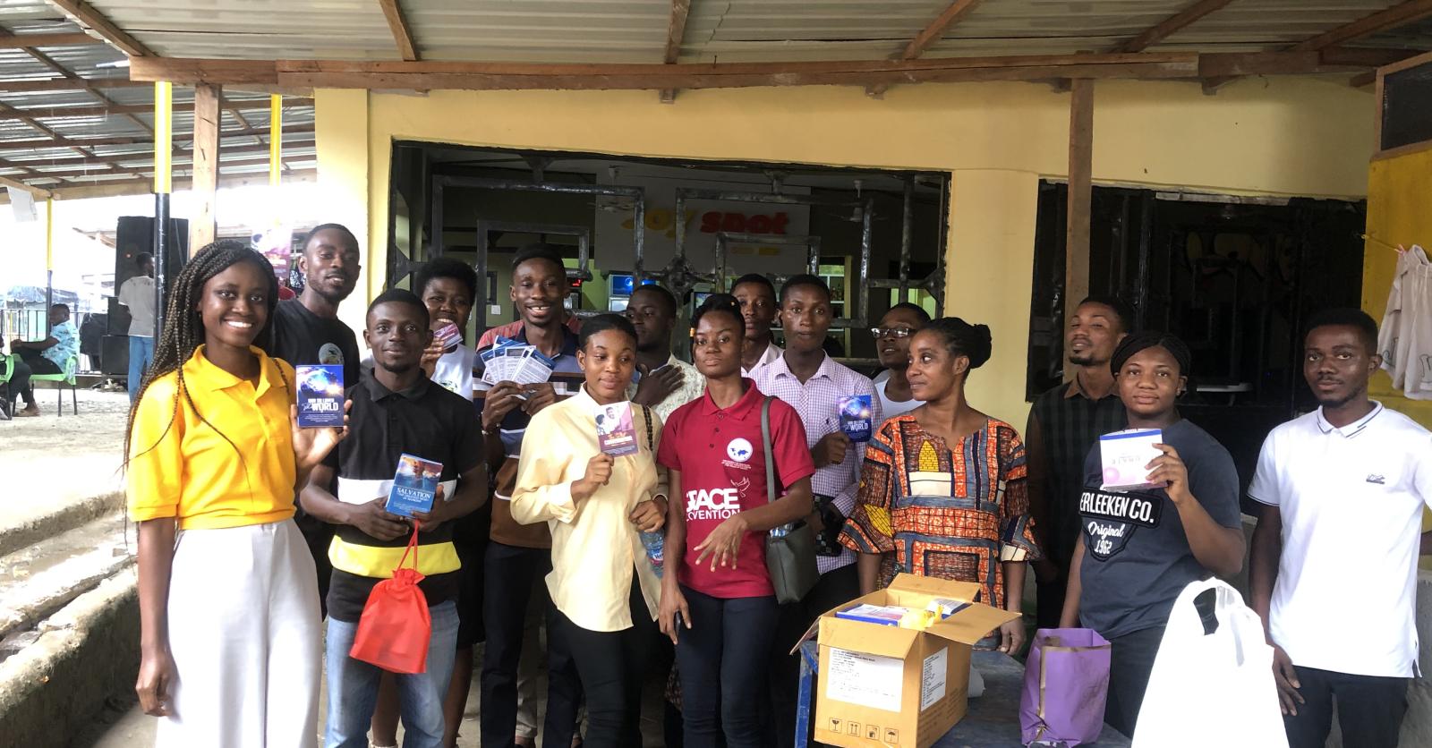 Students gathered with Gospel literature after a school outreach